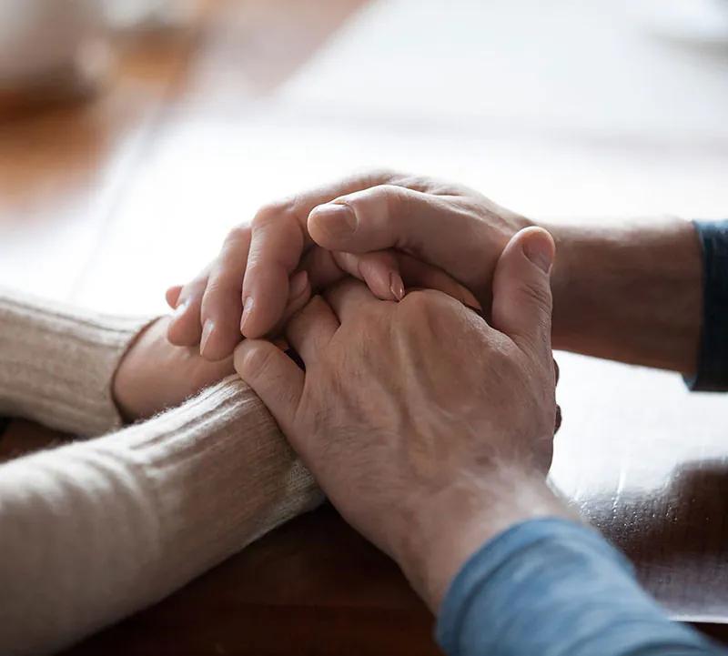 people-holding-hands-comforting-min